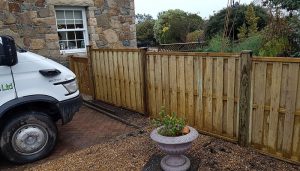 Small fence we erected at the bottom of a driveway. This is a wooden fence using solid wooden posts.