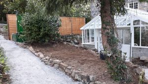 Repaired greenhouse in Guernsey with new walk way installed.
