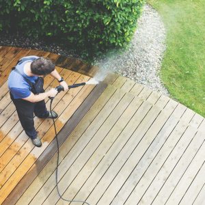 man cleaning terrace with a power washer